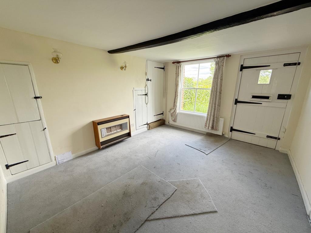 Lot: 165 - MID-TERRACE COTTAGE FOR IMPROVEMENT - Living room with window to front and entrance door